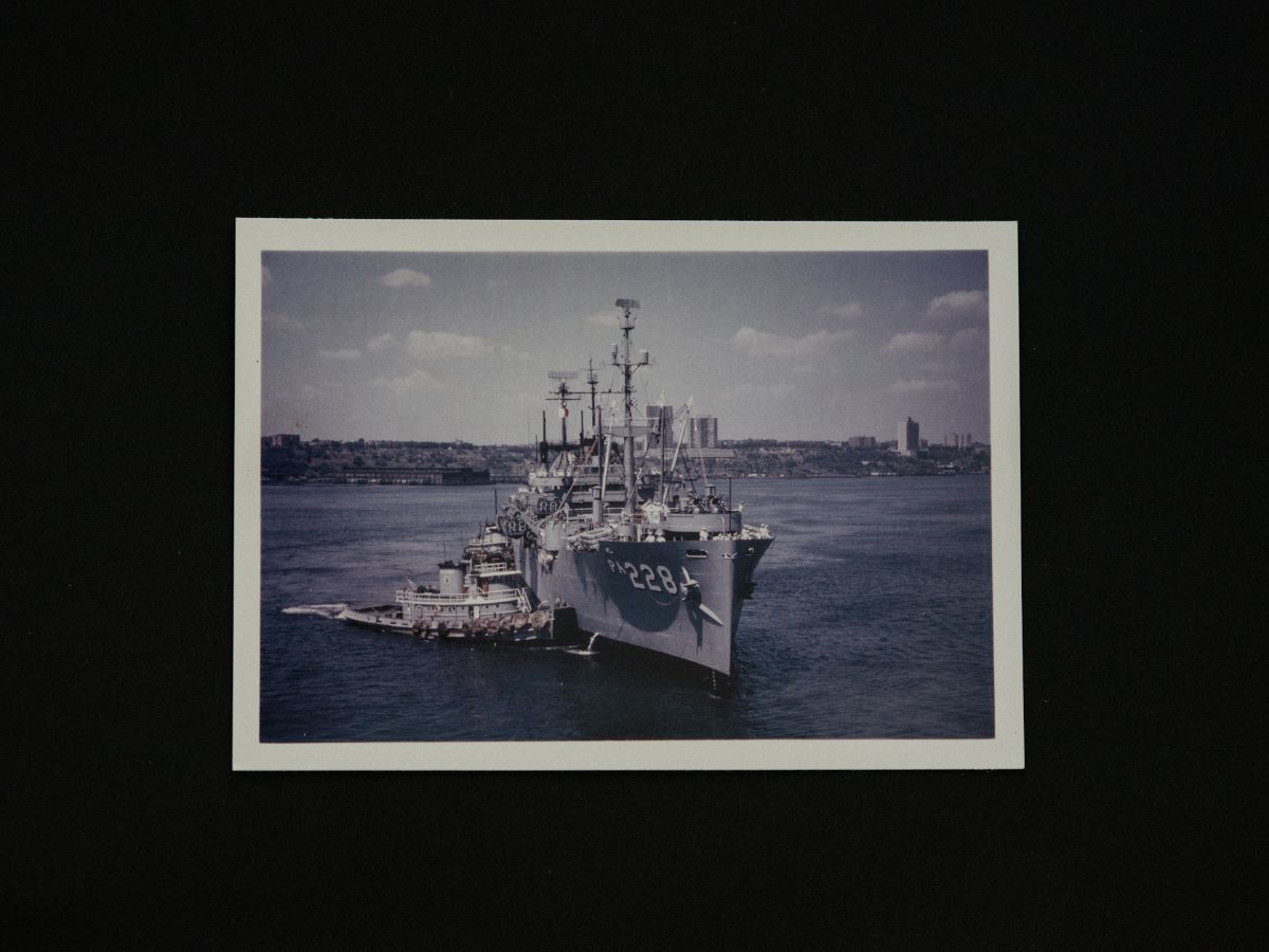 Photo of a warship navigating the water, symbolizing naval academy rivalries.
